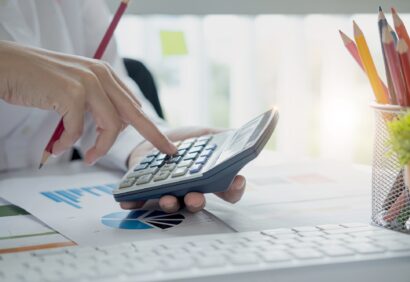 Close up view of bookkeeper or financial inspector hands making report, calculating or checking