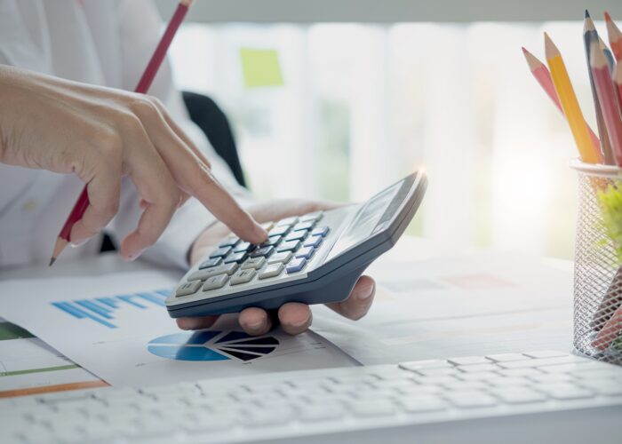Close up view of bookkeeper or financial inspector hands making report, calculating or checking