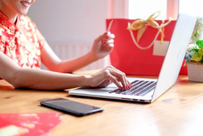 Happy chinese new year. Chinese woman in traditional clothing and shopping online.