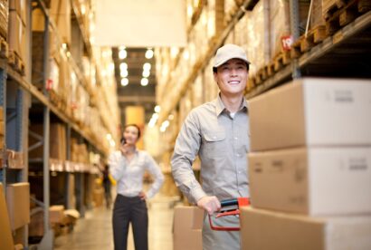 Male Chinese warehouse with Chinese businesswoman in the background